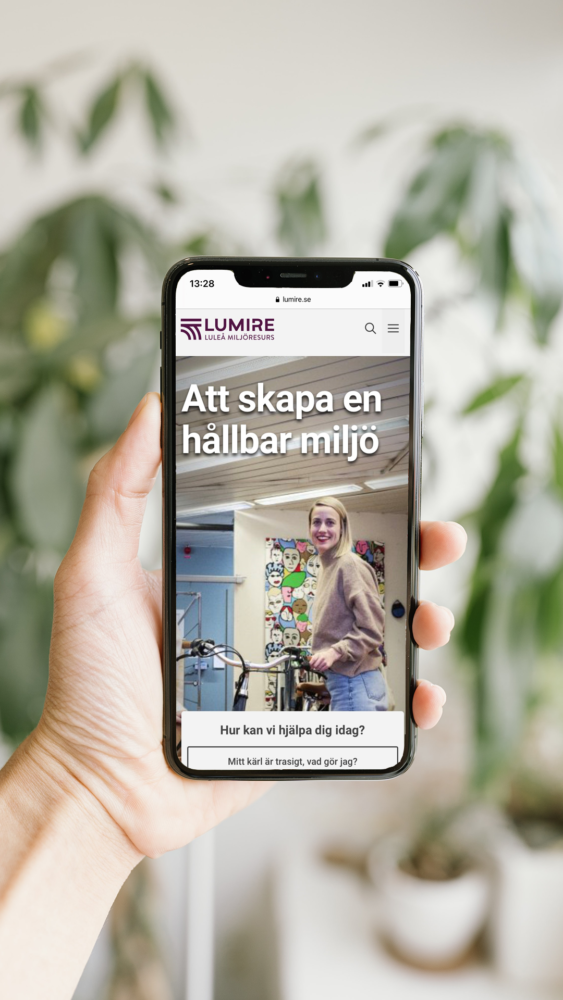 Bild på en hand som håller i en telefon.